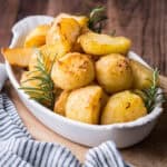 A bowl of cream baked roast potatoes, perfectly crisp and golden.