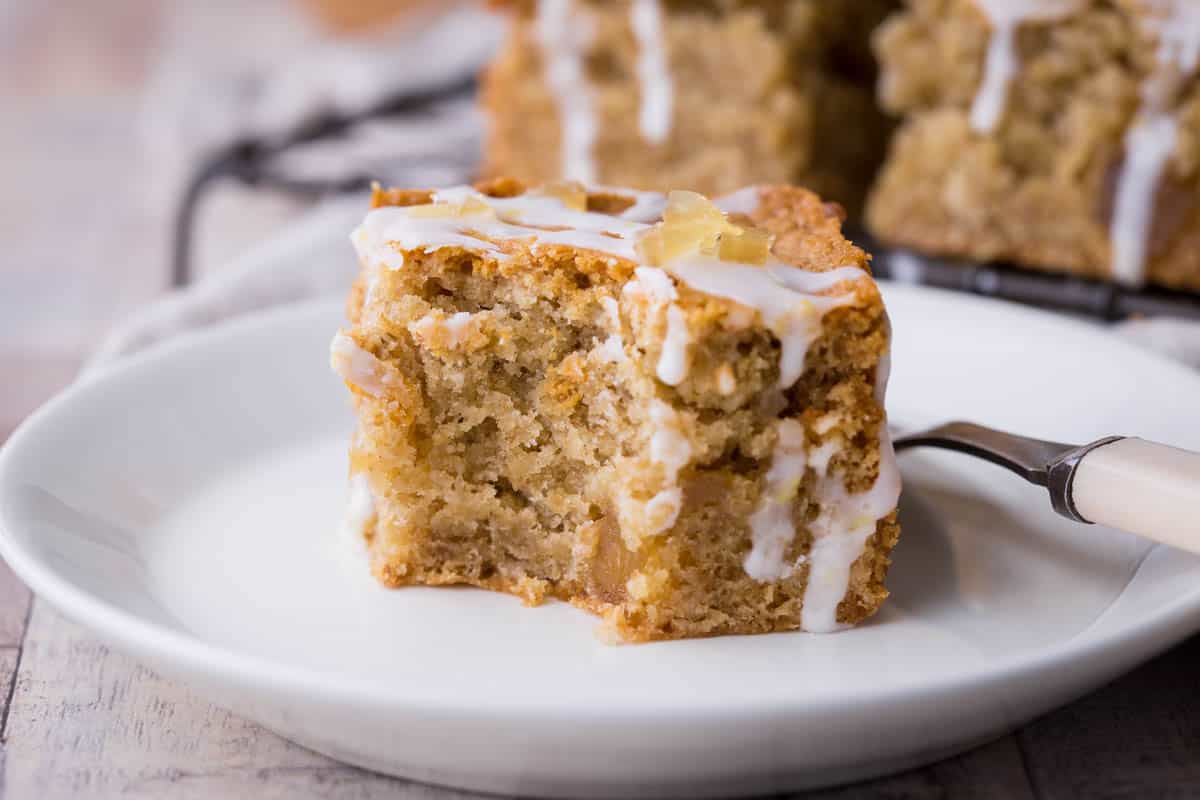 A piece of parkin on a plate with a bite taken out.
