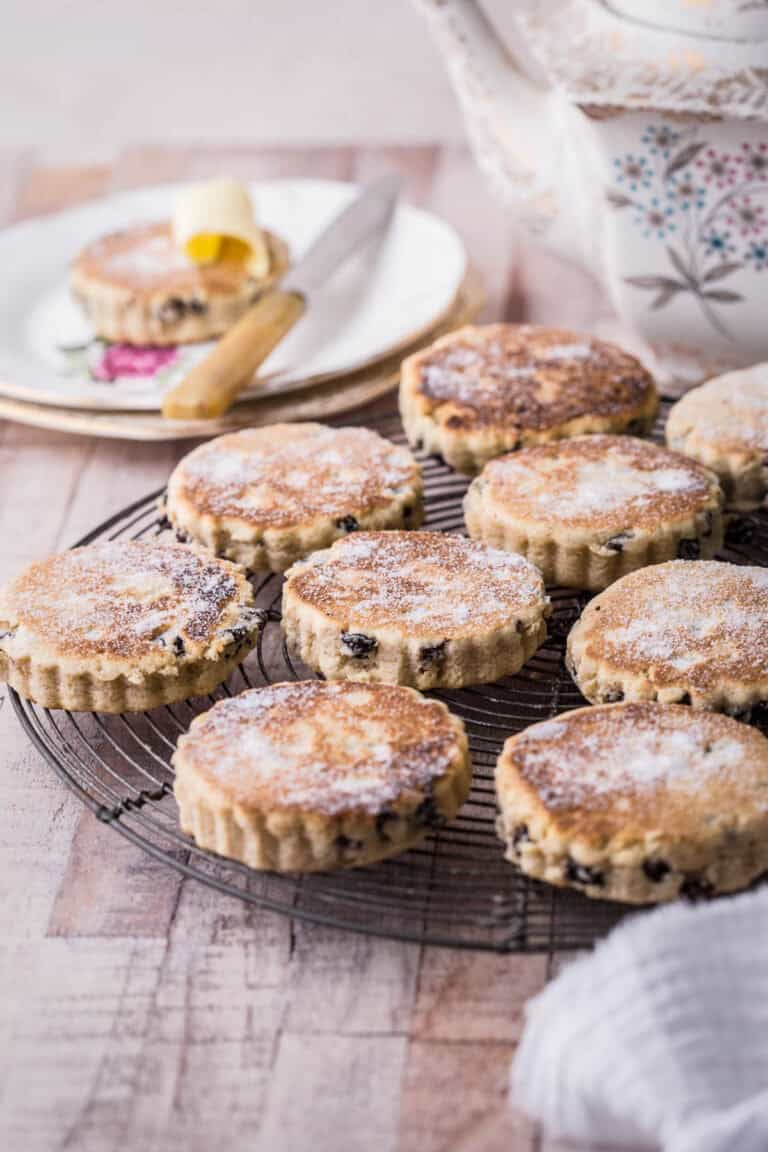 Welsh Cakes resting on a wire rack and dusted with caster sugar.