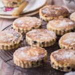 Welsh Cakes resting on a wire rack and dusted with caster sugar.
