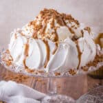 Sticky Toffee Pavlova on a glass stand.