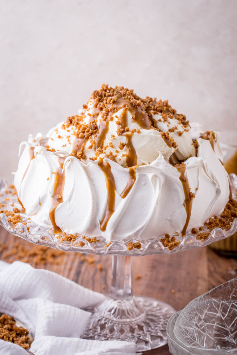 Sticky Toffee Pavlova on a glass stand.