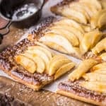 Gluten-Free Apple Tart cut into 8 slices and dusted with icing sugar.