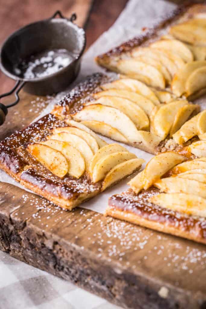 Gluten-Free Apple Tart cut into 8 slices and dusted with icing sugar.