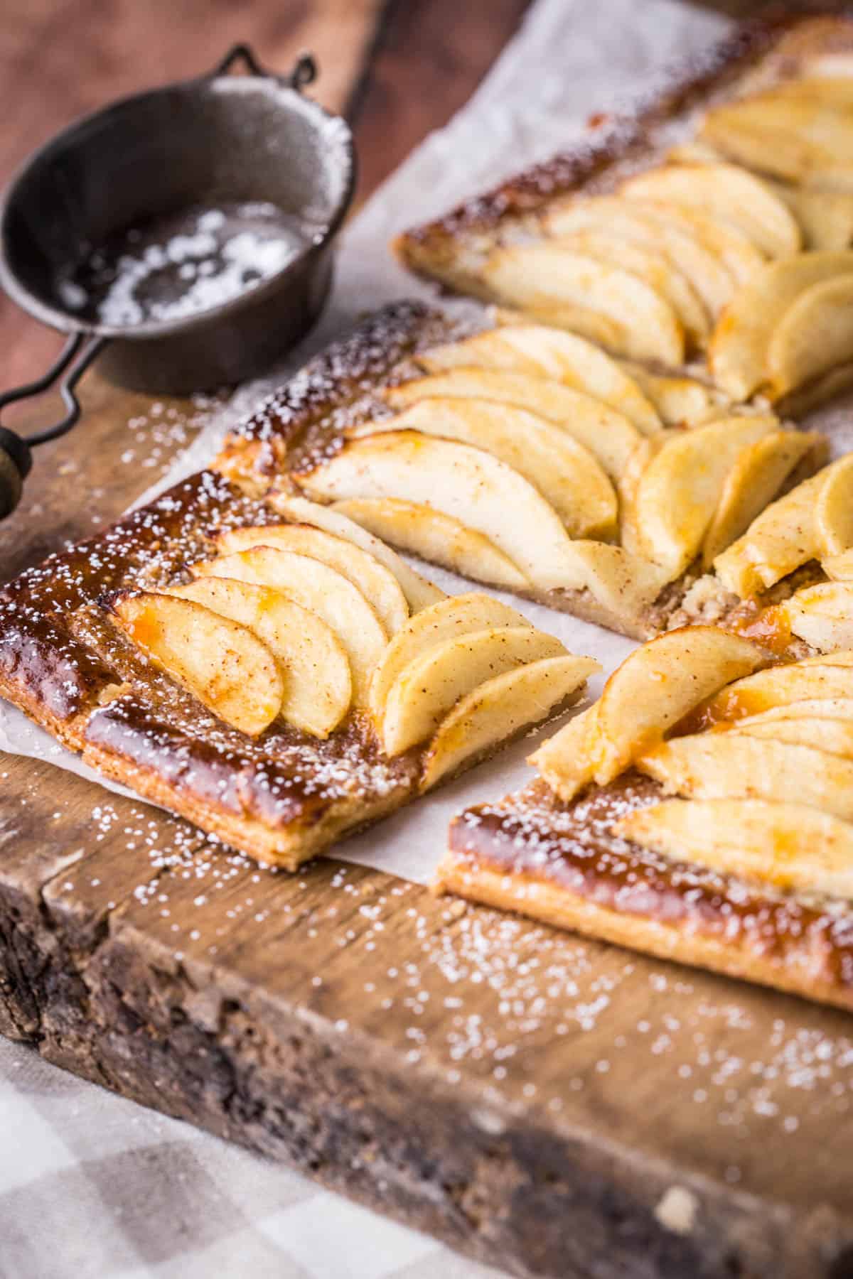 Gluten-Free Apple Tart cut into 8 slices and dusted with icing sugar.