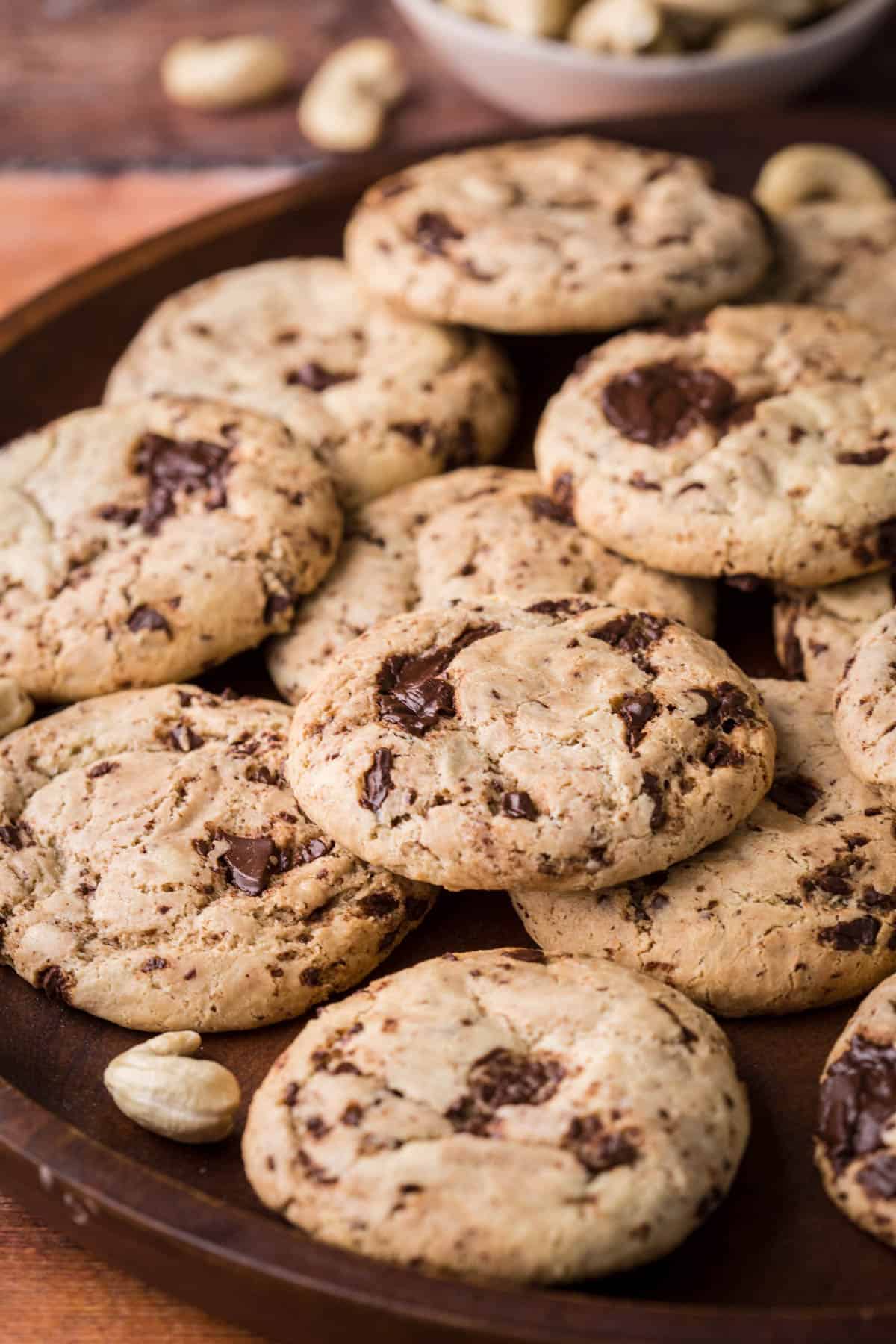 A pile of Cashew Butter Cookies with molten chocolate puddles.