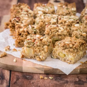 Apple flapjacks shown from the side so you can see the nutty topping, the buttery oat mixture and the fluffy bramley apple middle.