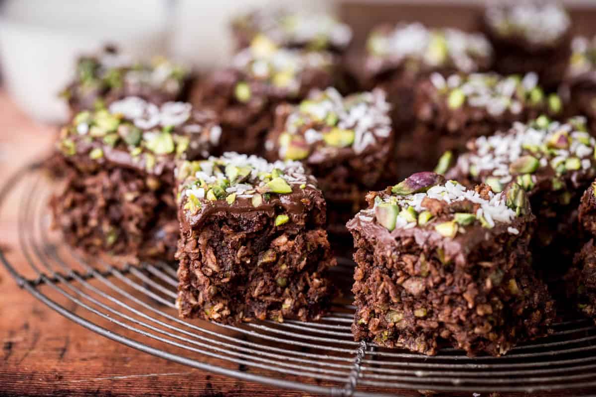 Flourless Chocolate Pistachio Coconut Slice on a wire rack.