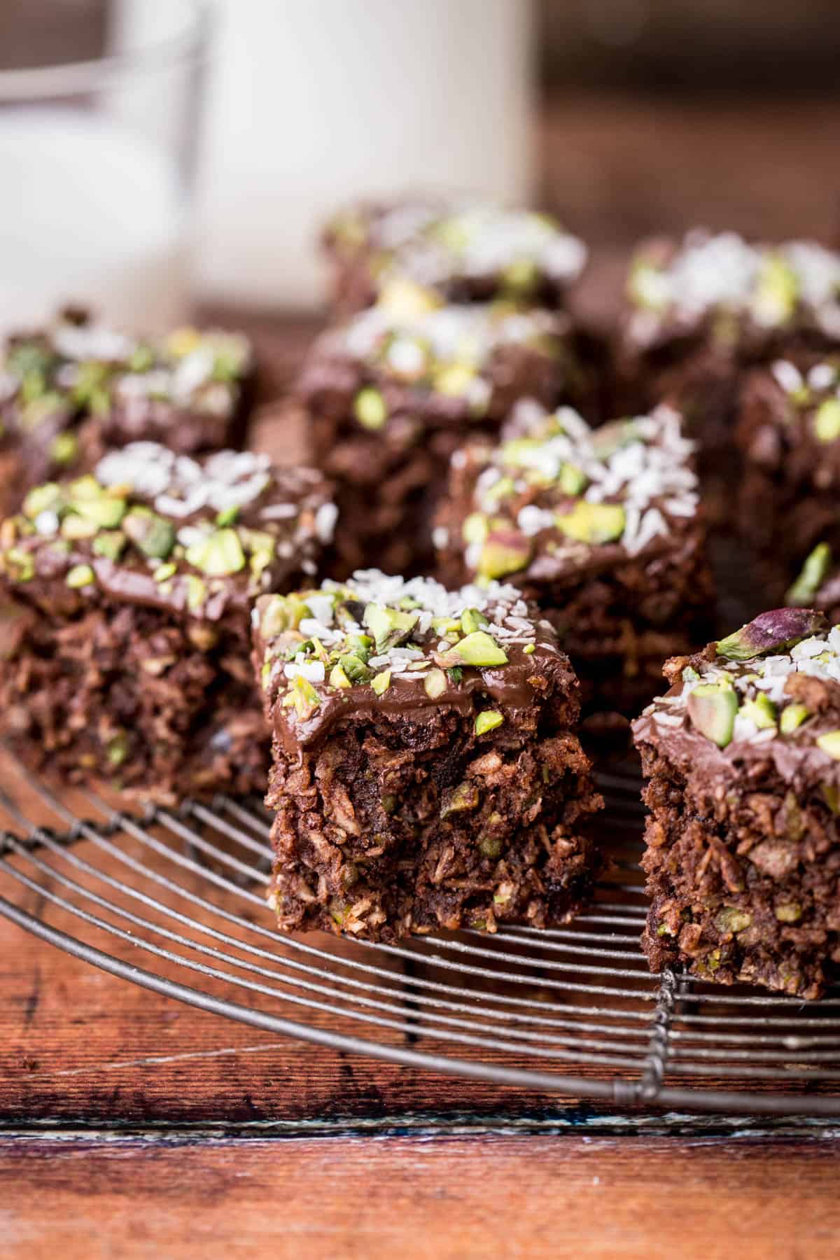 Flourless Chocolate Pistachio Coconut Slice on a wire rack.