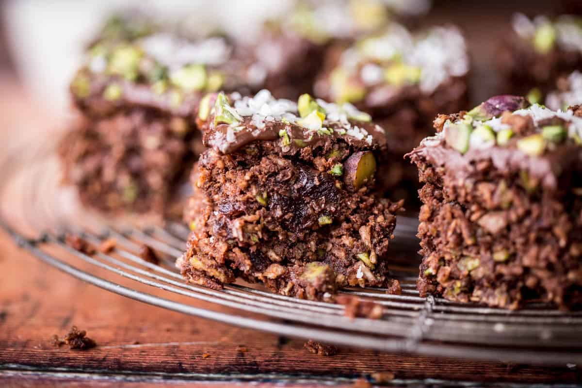Flourless Chocolate Pistachio Coconut Slice on a wire rack.