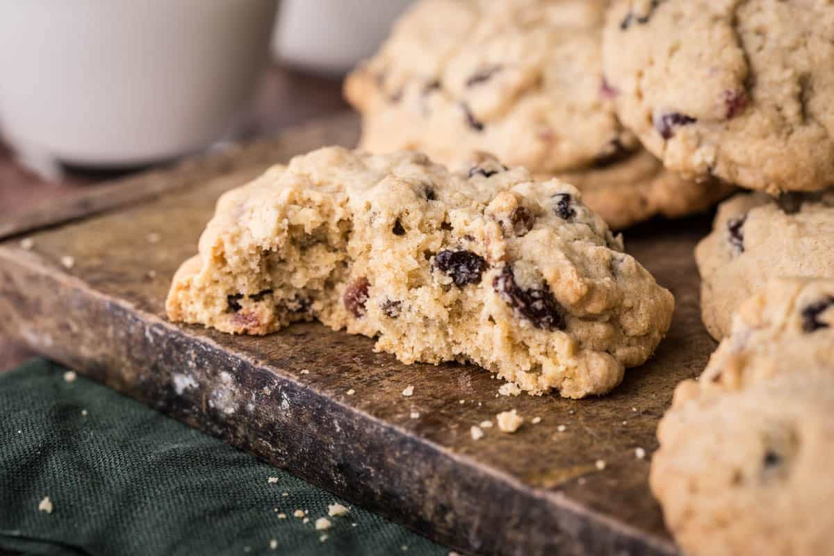 Gluten-Free Rock Cake on a table, halved showing tender crumb stuffed with dried fruits.