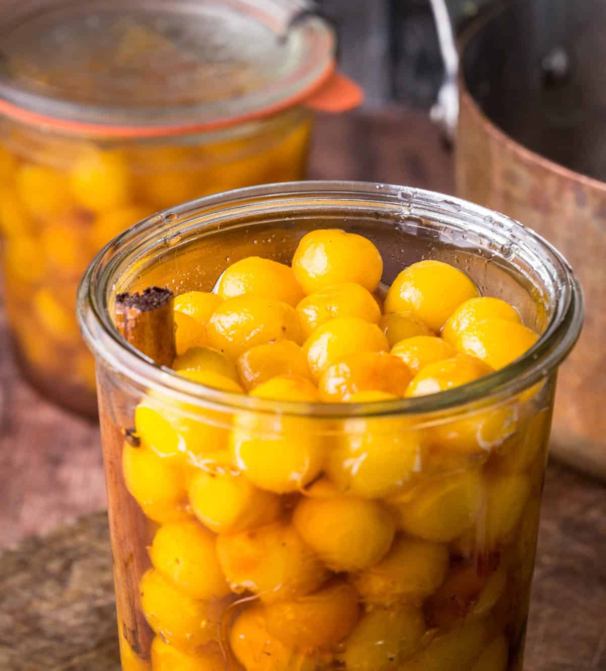 Pickled mirabelles packed into a sterilised jar.