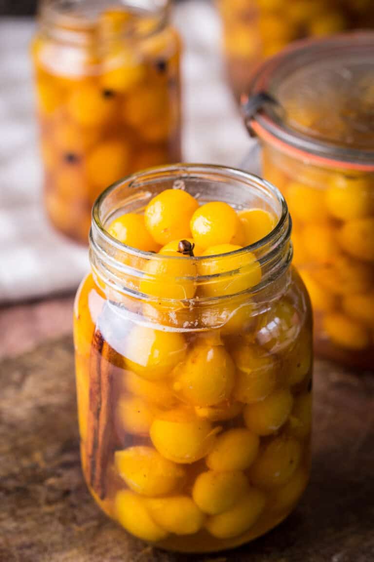 Pickled mirabelles packed into a sterilised jar.