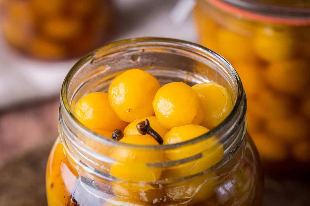 Pickled mirabelles packed into a sterilised jar.