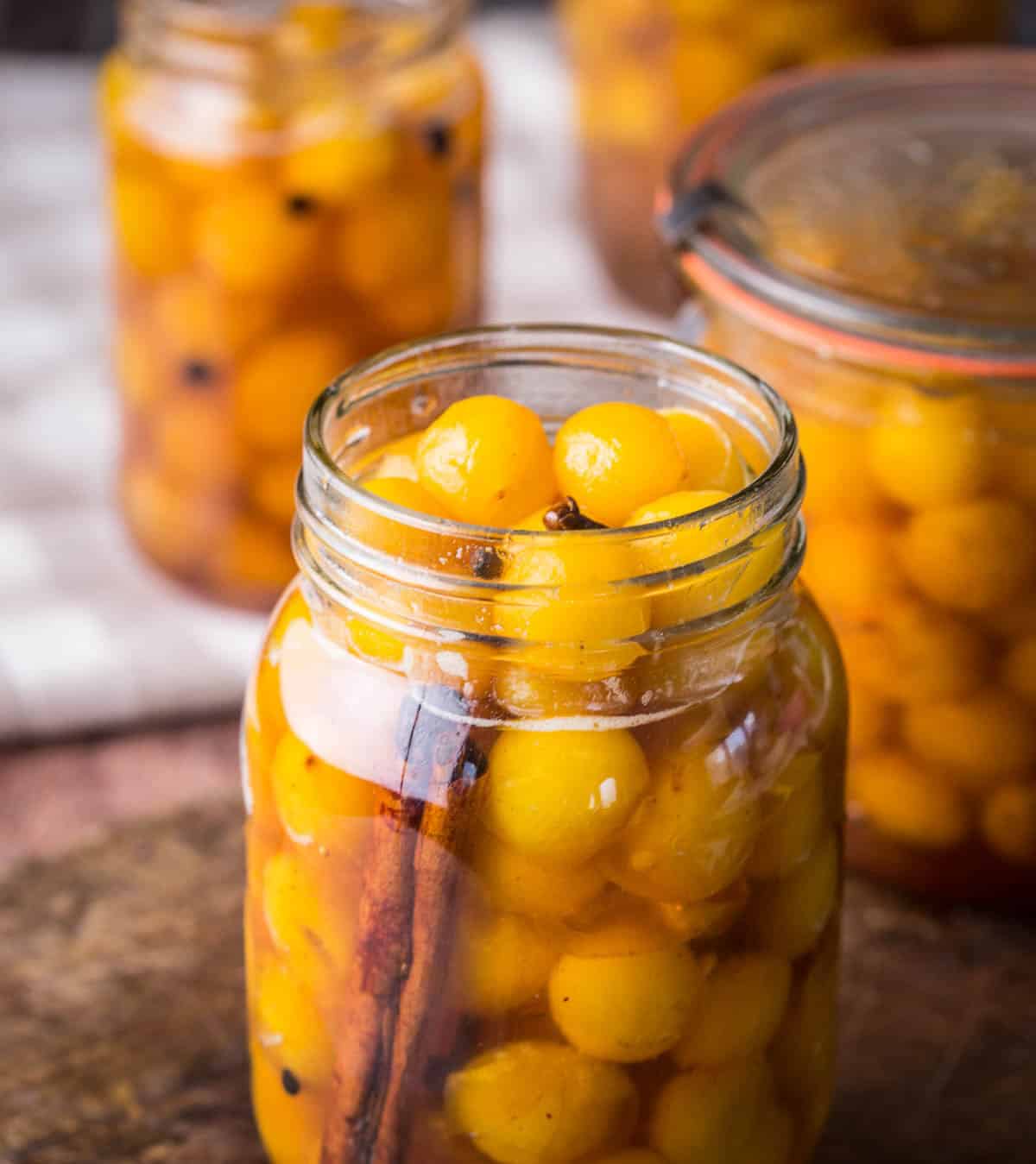 Pickled mirabelles packed into a sterilised jar.