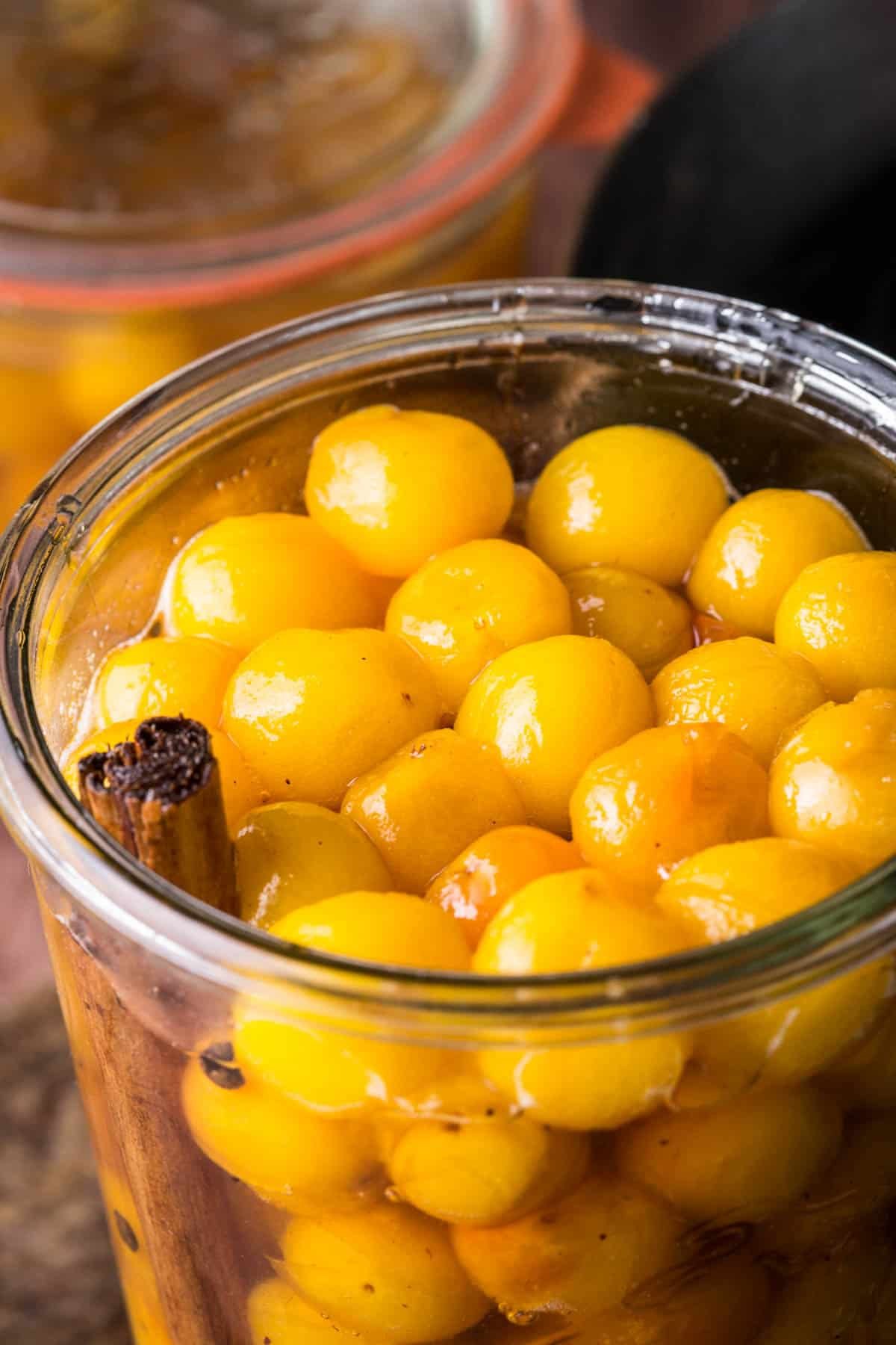 Pickled mirabelles packed into a sterilised jar.