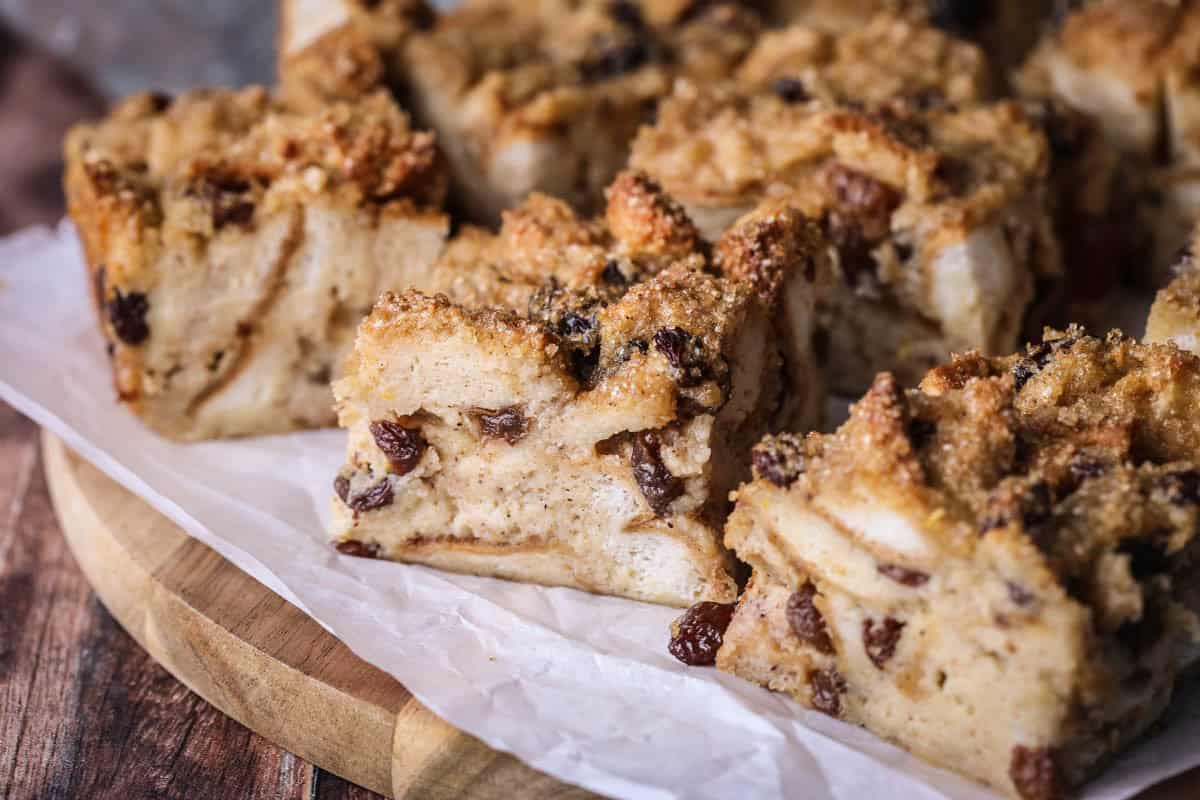 Sliced bread pudding showing creamy soft pudding with crunchy sugar topping.