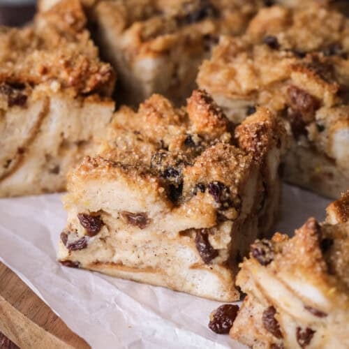 Sliced bread pudding showing creamy soft pudding with crunchy sugar topping.