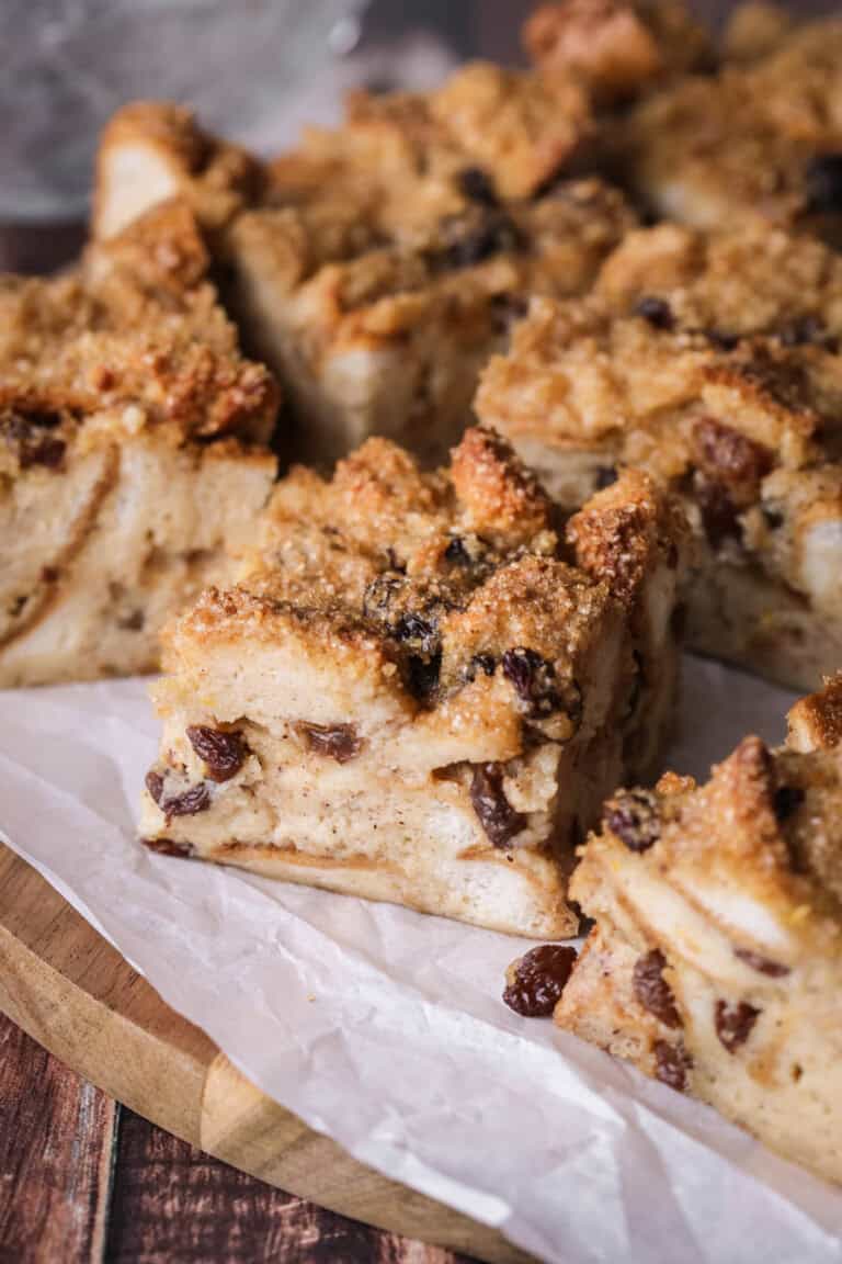 Sliced bread pudding showing creamy soft pudding with crunchy sugar topping.