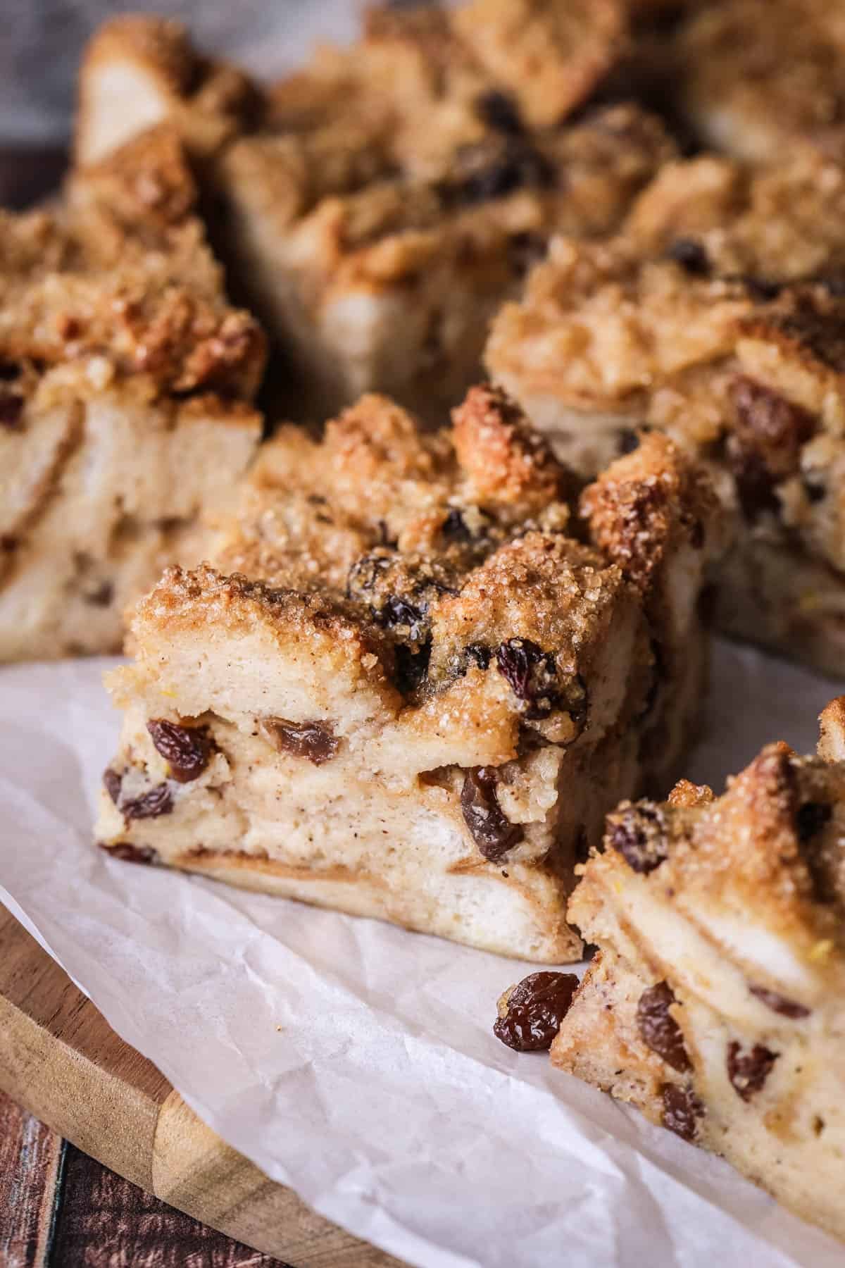 Sliced bread pudding showing creamy soft pudding with crunchy sugar topping.