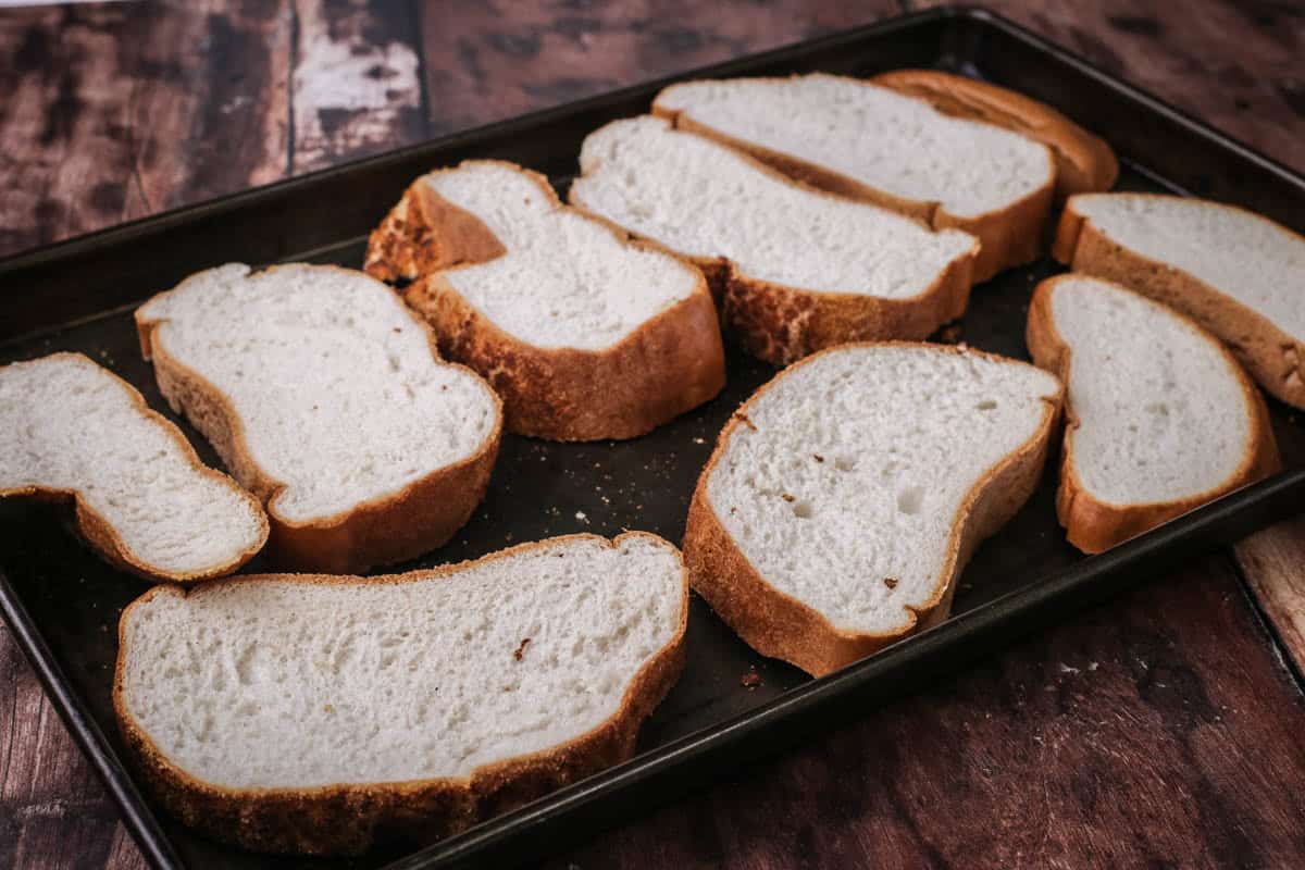 Slices of gluten-free bread on a pan.