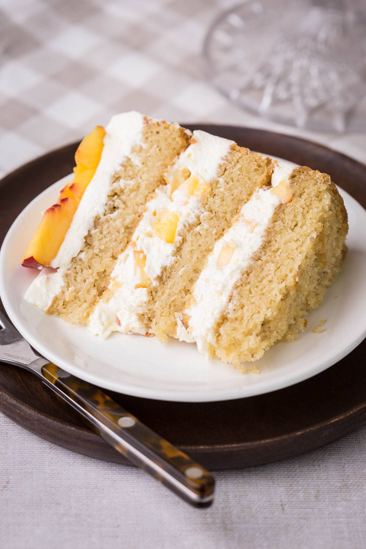 Slice of Nectarine Thyme Limoncello Cake on a plate.