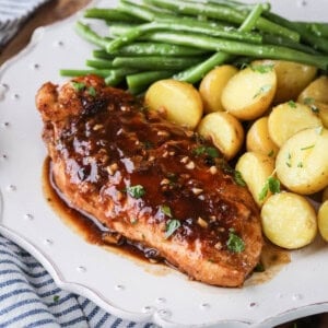 Devilled Chicken on a plate with new potatoes and green beans.