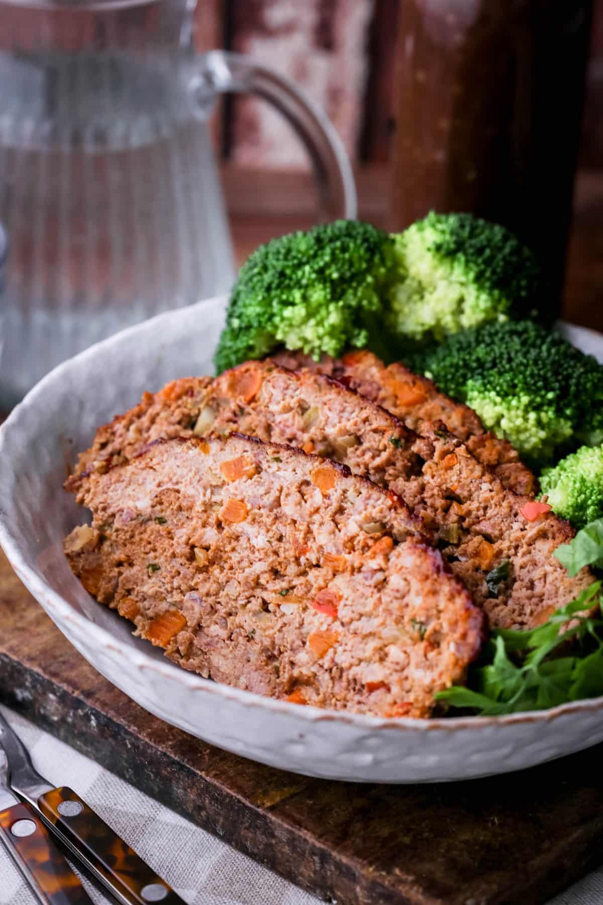 Gluten-Free Meatloaf sliced in a bowl with broccoli.