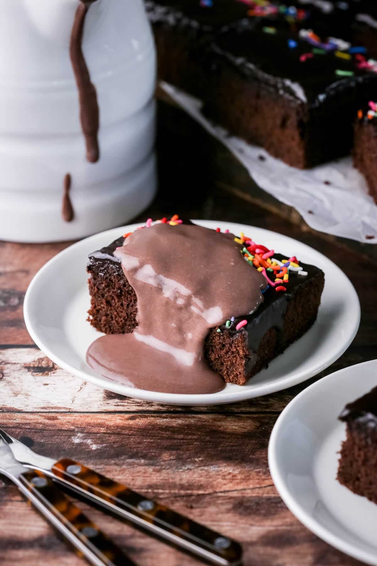 Slice of Chocolate School Cake topped with creamy chocolate custard.