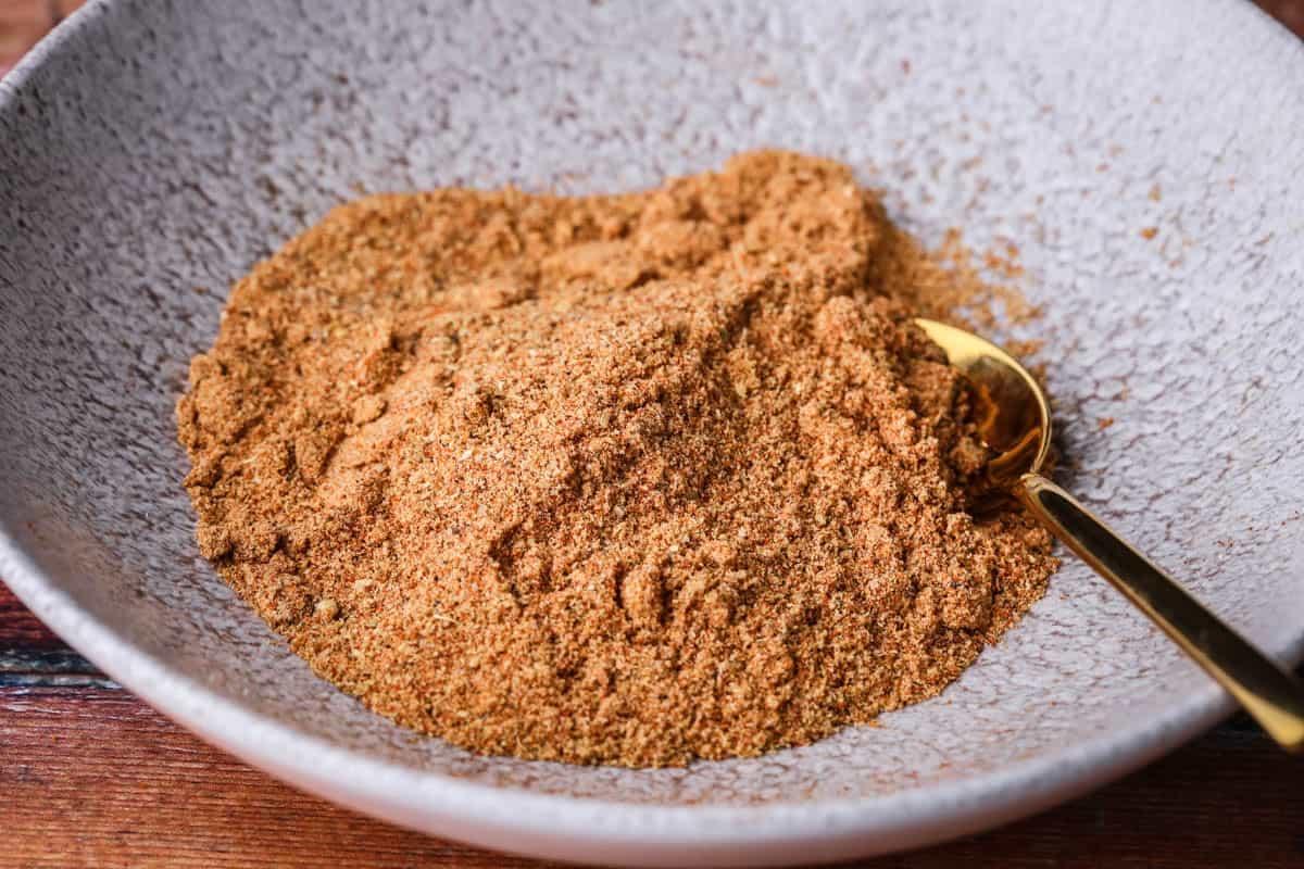 Ground Everyday Seasoning Blend in a bowl with a spoon.