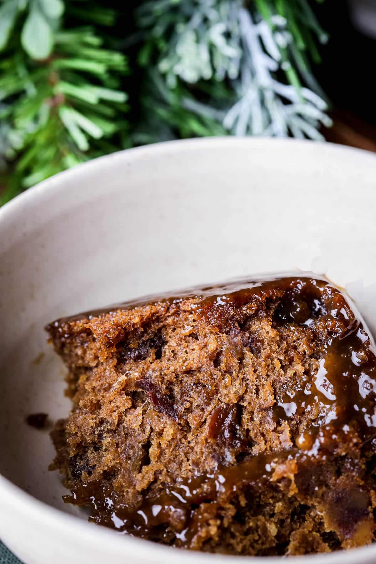 Sticky Toffee Christmas Pudding in a bowl.