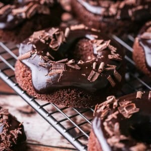 Chocolate glaze topped on chocolate doughnuts and decorated with chocolate curls.