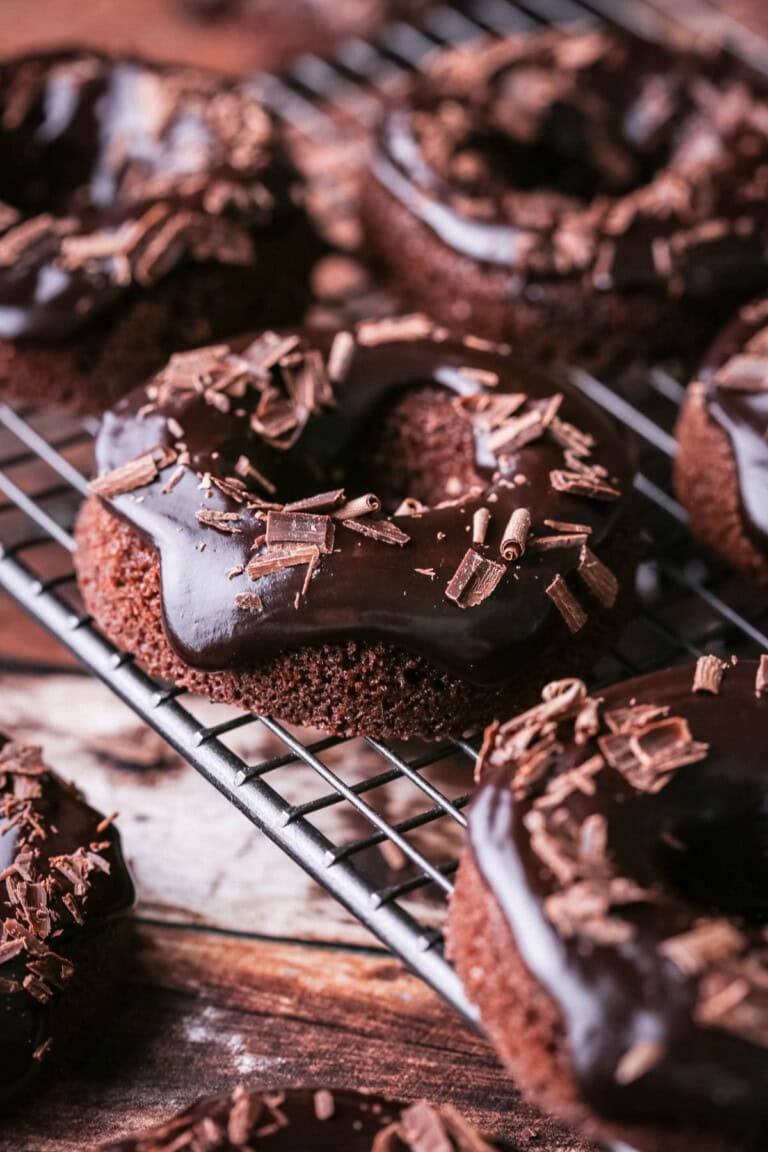 Chocolate glaze topped on chocolate doughnuts and decorated with chocolate curls.