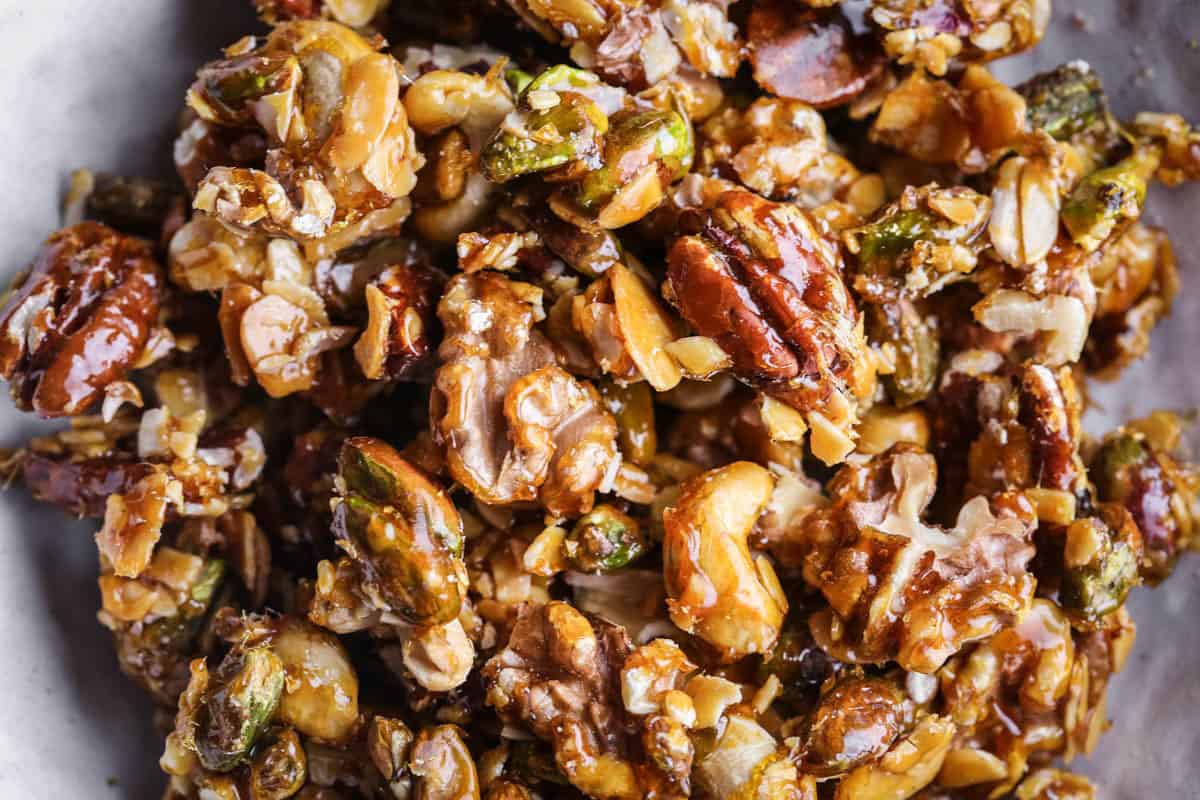 Caramelised Mixed Nuts showing glossy walnuts, pistachios. cashews, flaked almonds and pecans.
