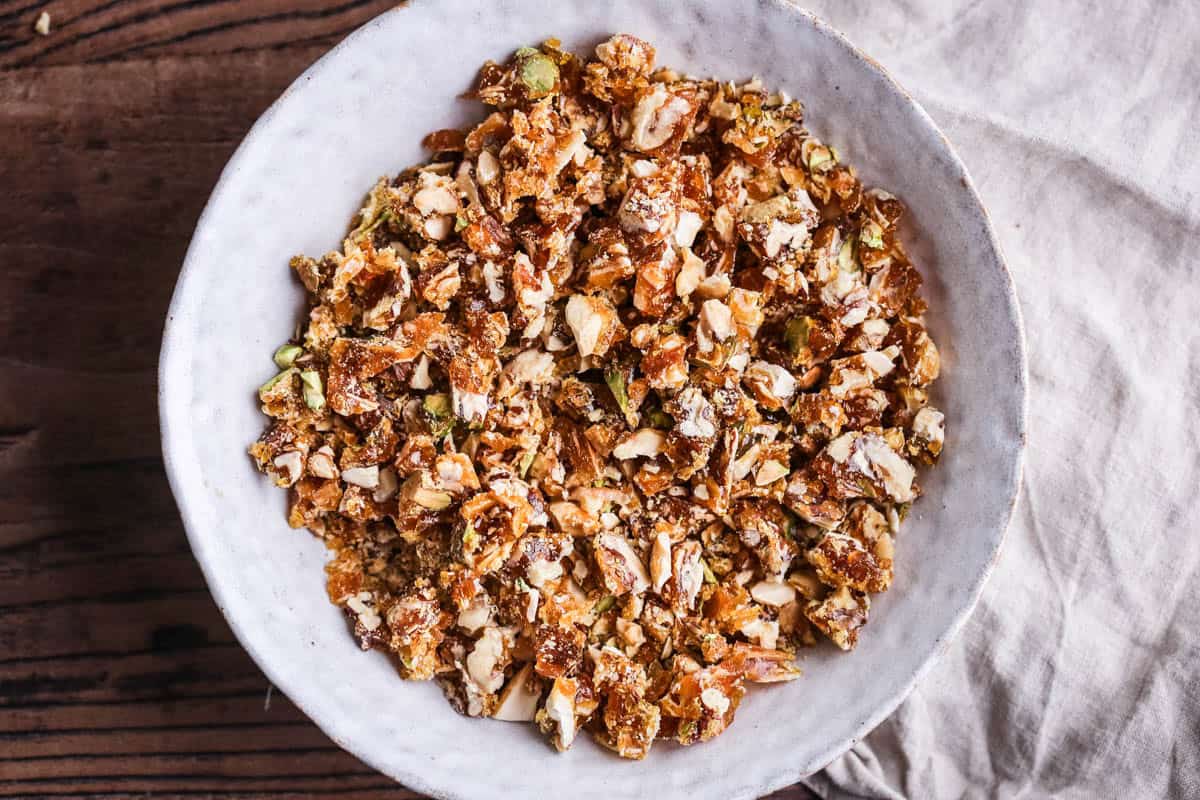 Caramelised nuts chopped into fine shards in a bowl.
