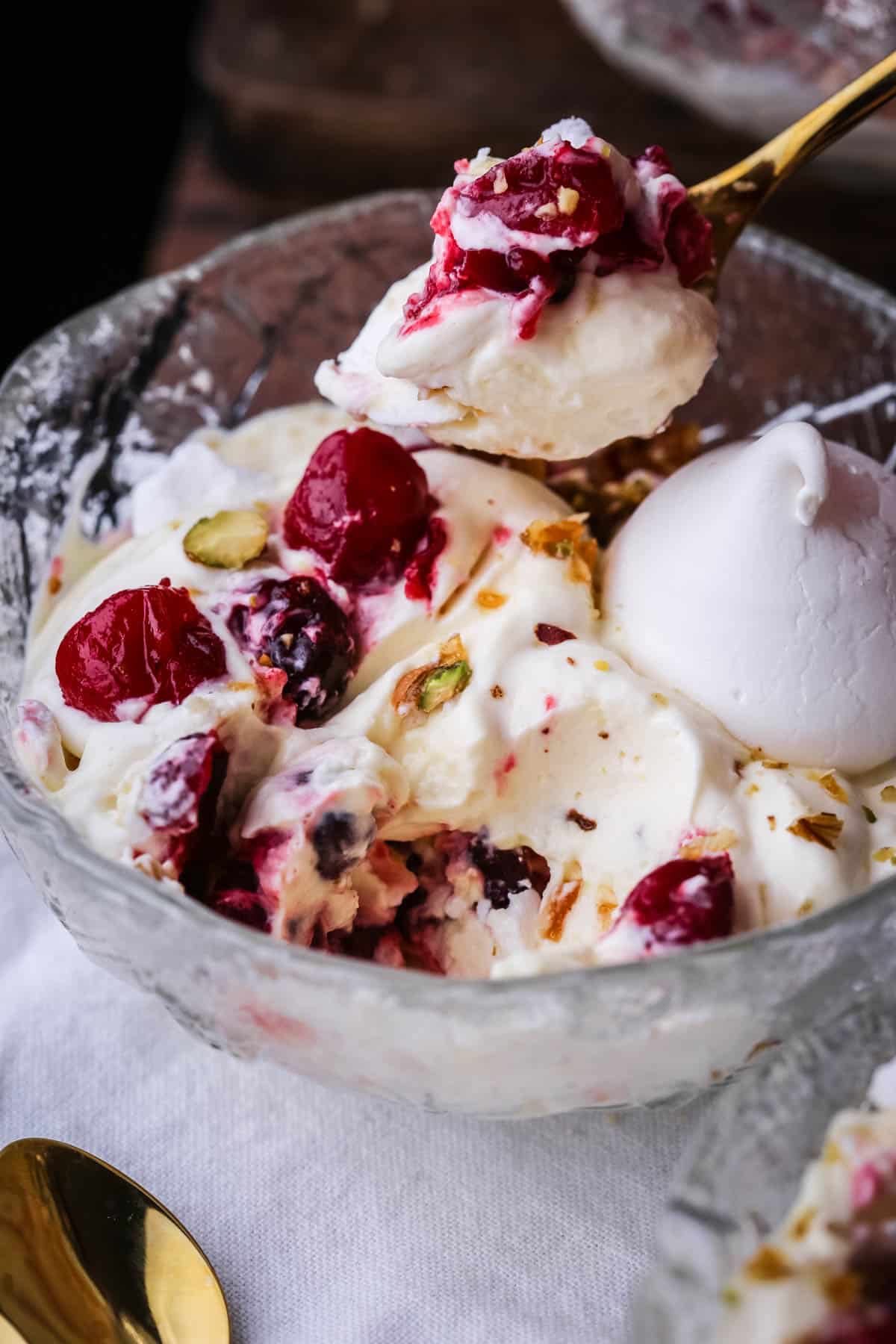 Festive Eton Mess in a bowl with spoonful taken out.