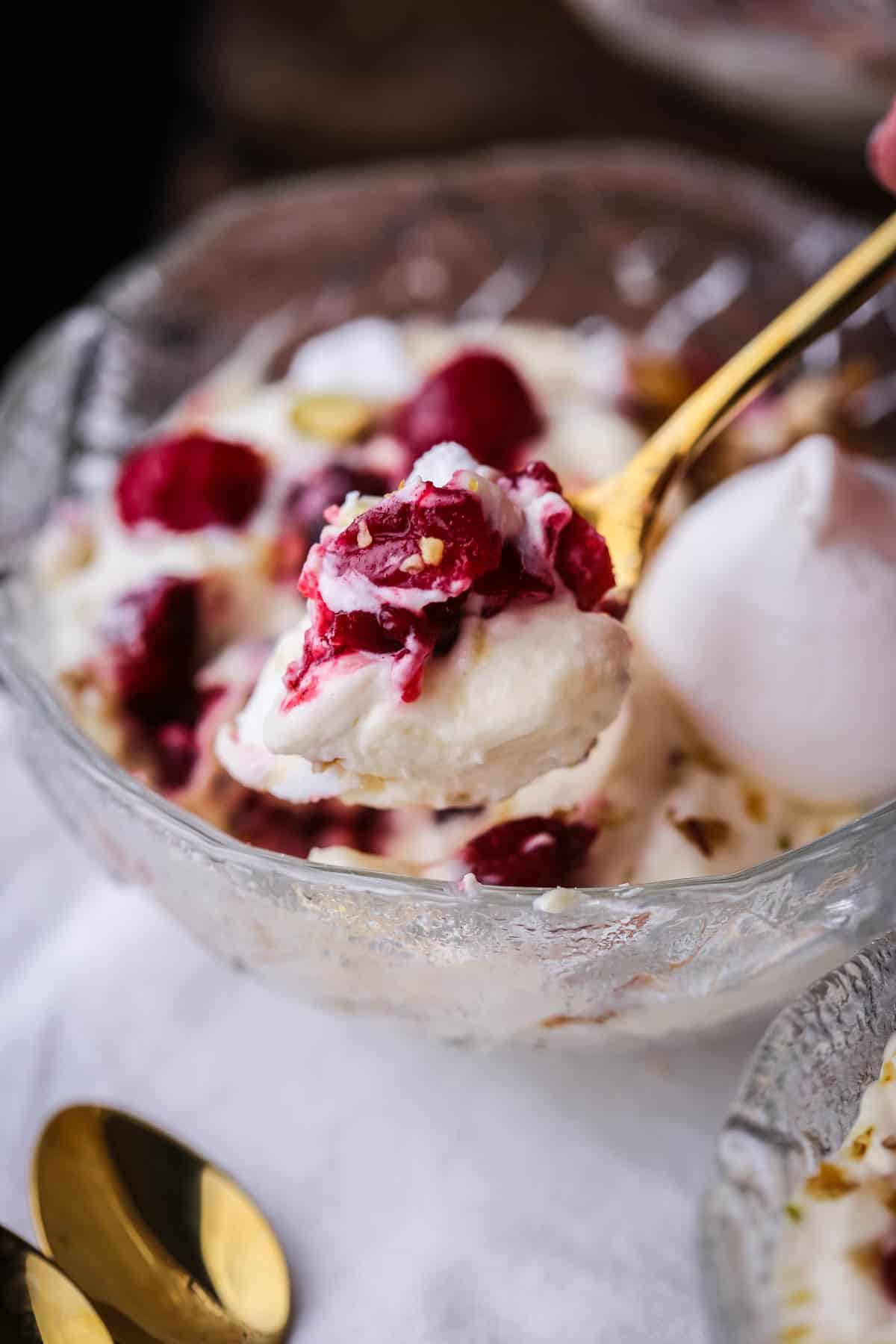 Festive Eton Mess in a bowl with spoonful taken out.