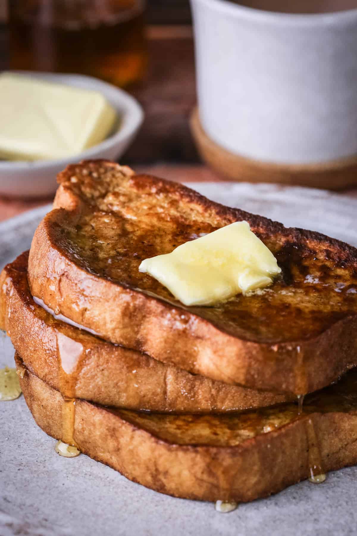 Gluten-Free French Toast with melted butter and honey dripping down.