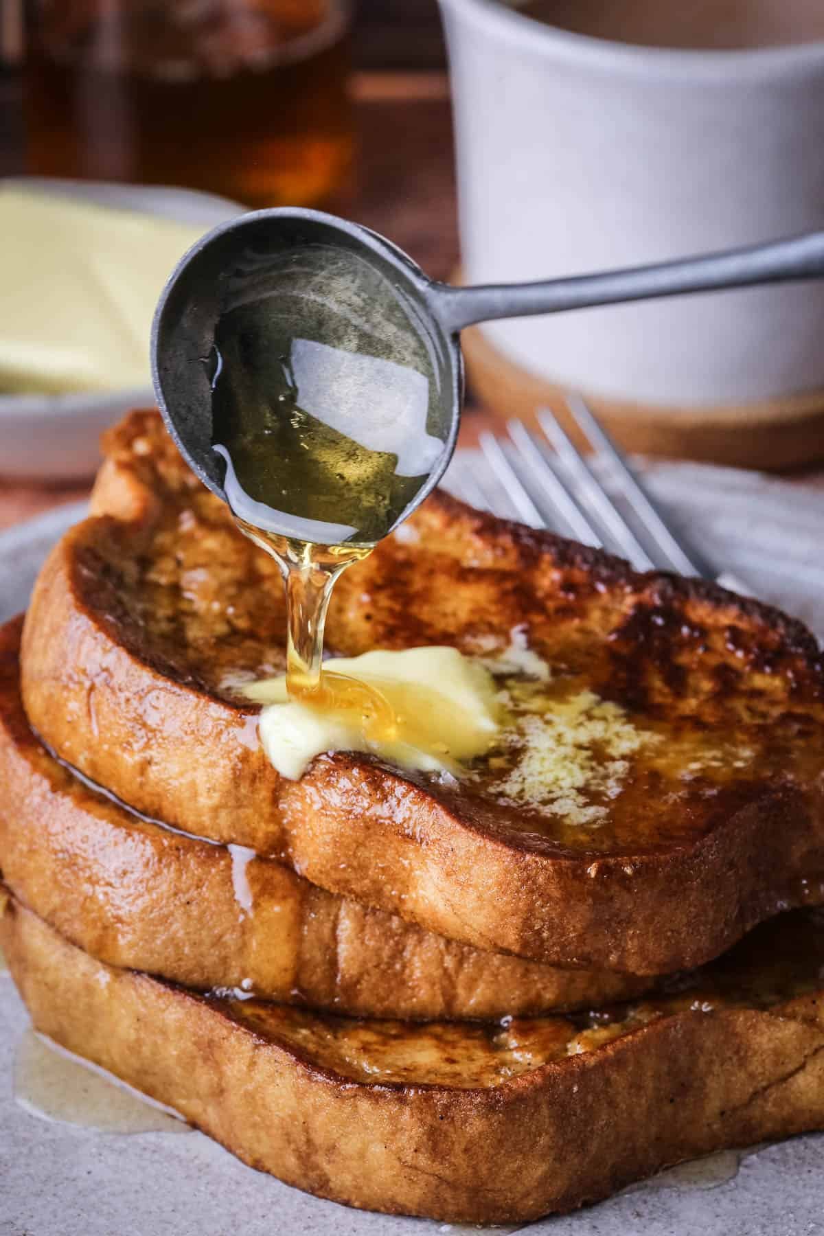 Gluten-Free French Toast with melted butter and honey poured over the top.