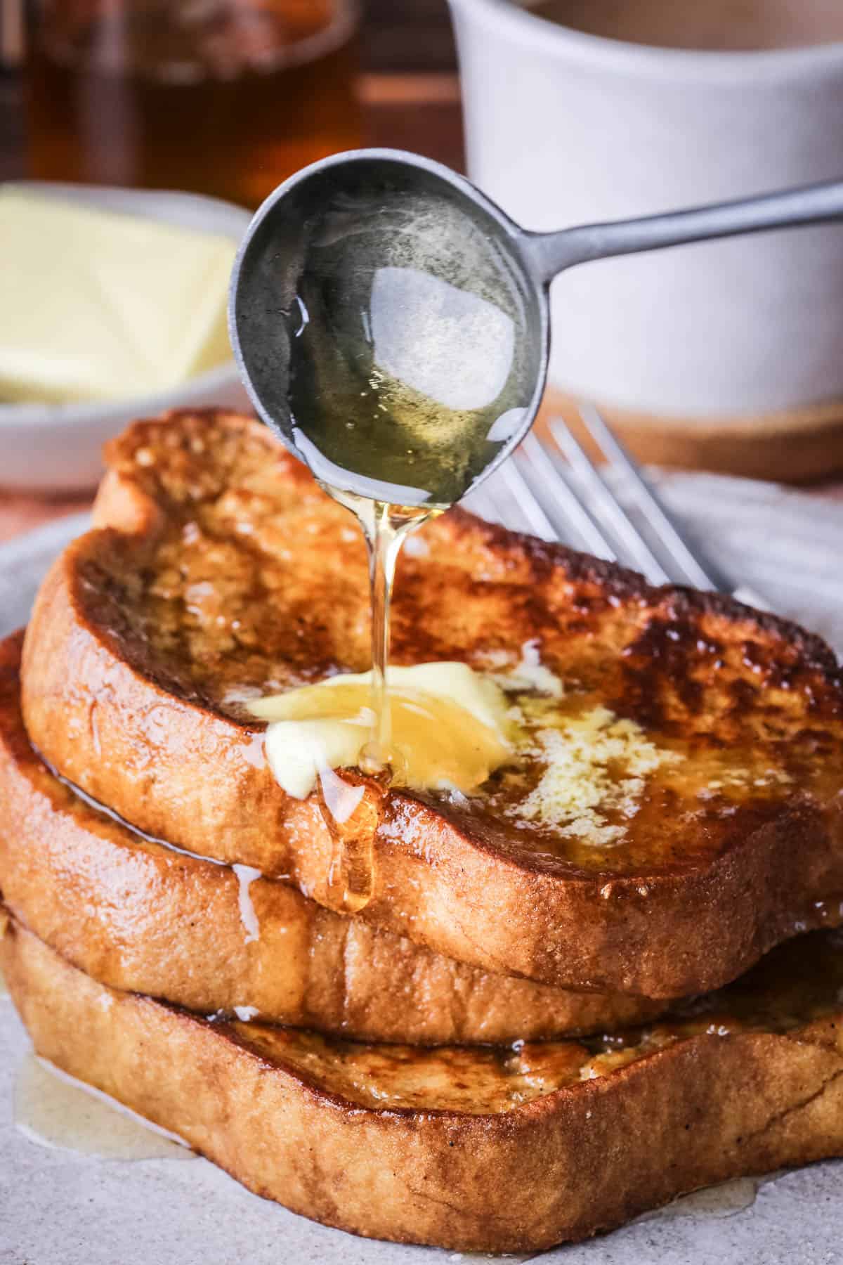 Gluten-Free French Toast with melted butter and honey poured over the top.