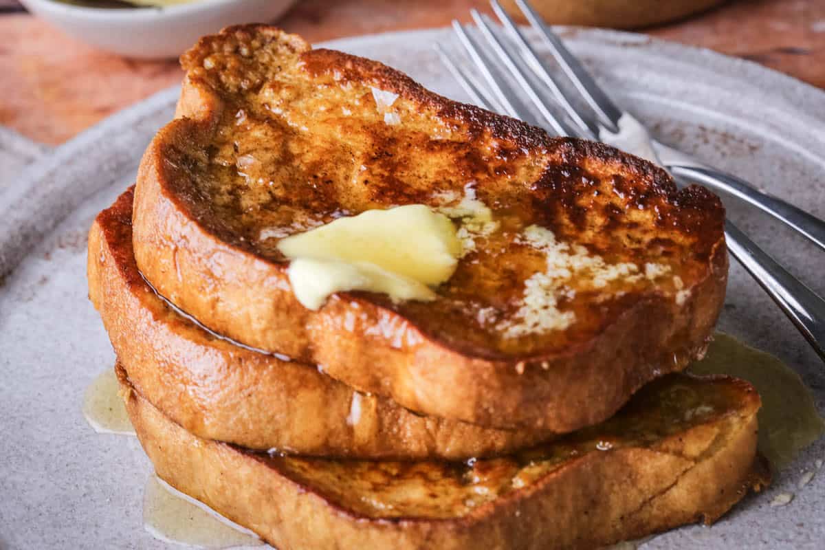 Gluten-Free French Toast with melted butter and honey dripping down.