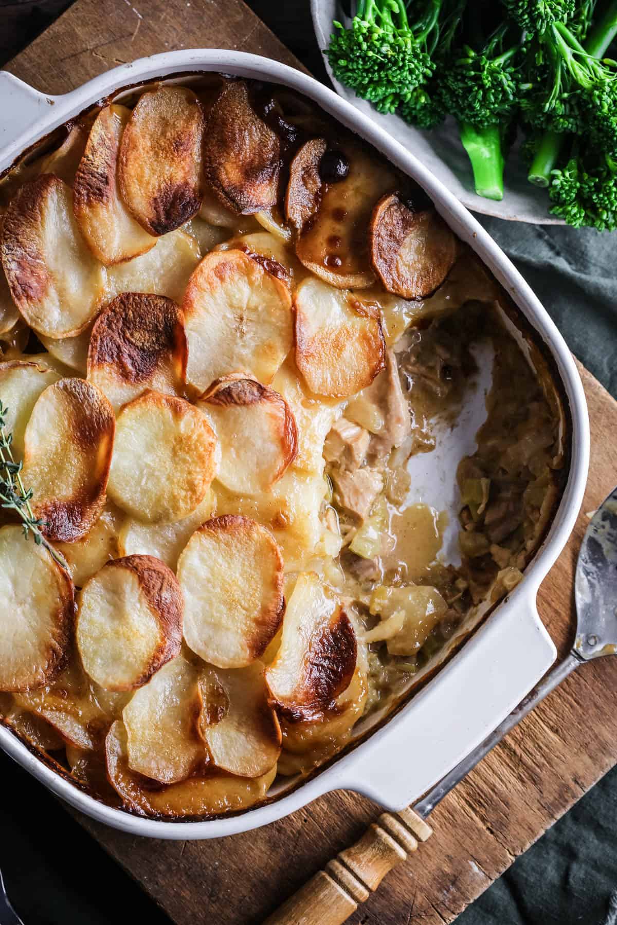 An ovenproof serving dish filled with Turkey Hotpot with creamy turkey filling covered with crisp layered potatoes.