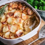 An ovenproof serving dish filled with Turkey Hotpot with creamy turkey filling covered with crisp layered potatoes.