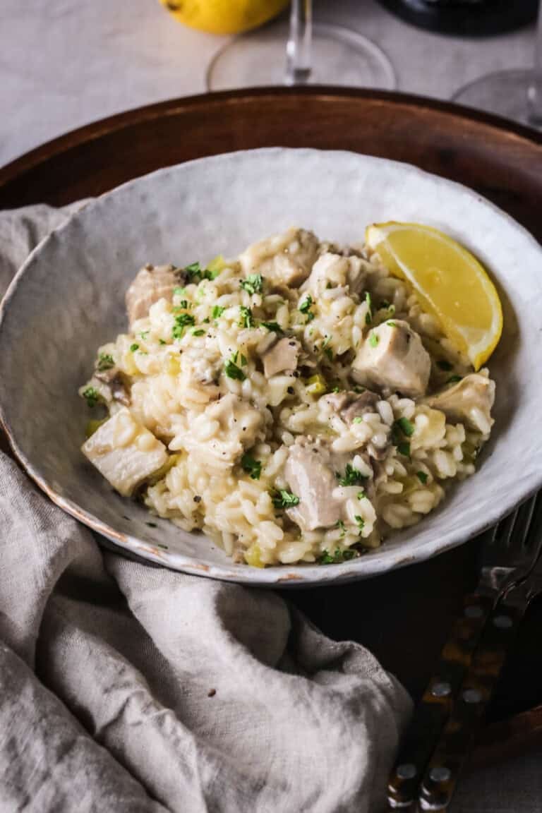 A bowl of silky Turkey Risotto showing creamy texture with juicy turkey.