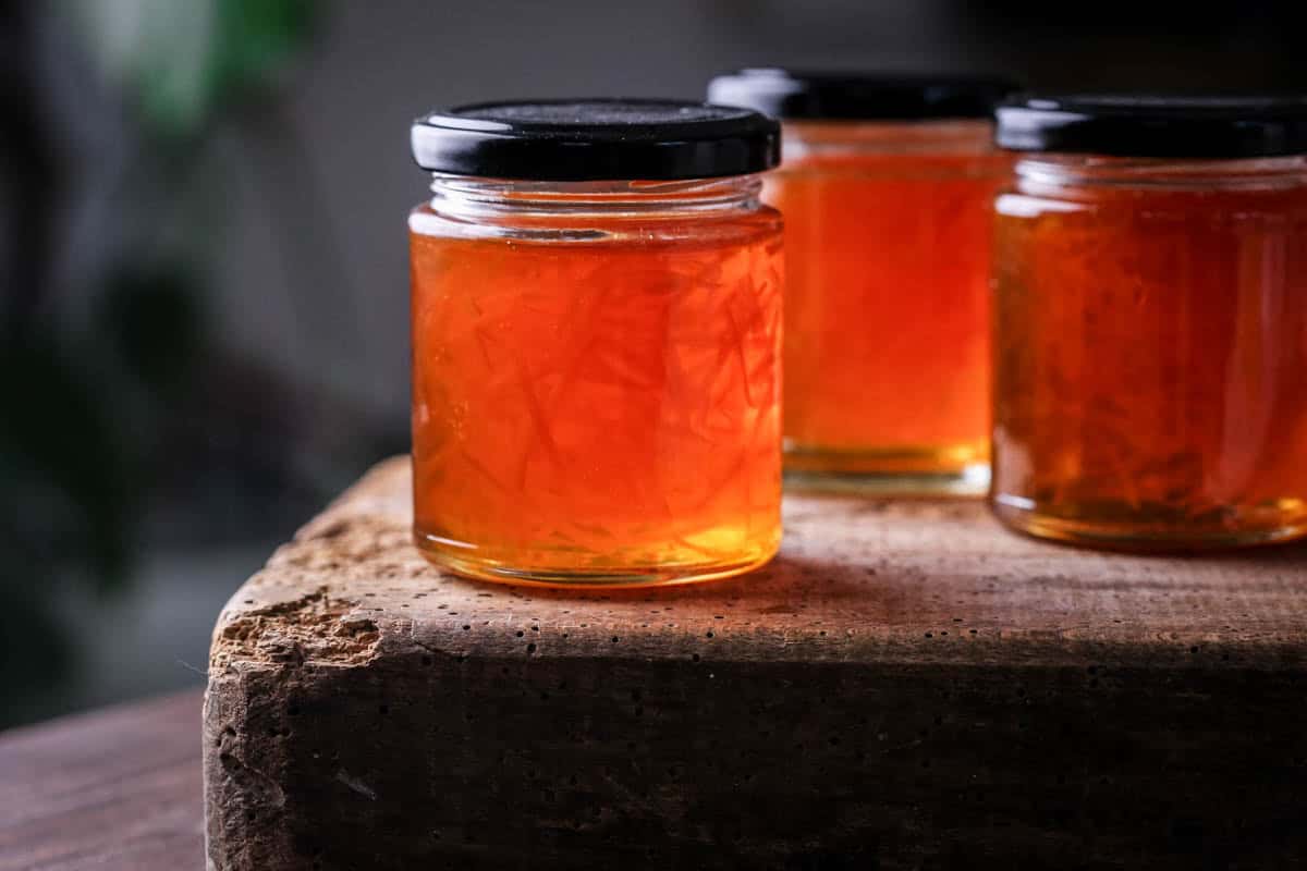 Jar of marmalade showing clear set and peel suspended throughout.