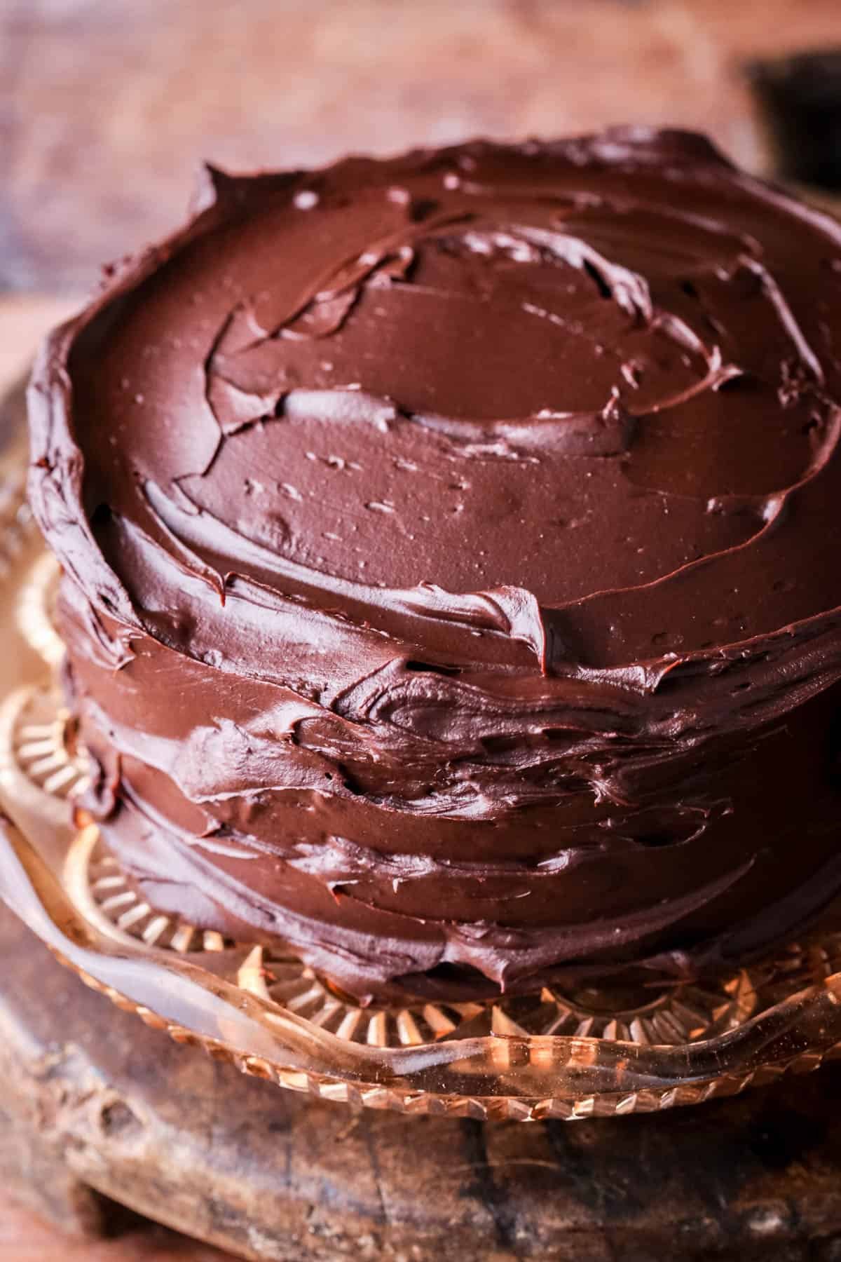 Finished Chocolate Fudge Cake showing glossy rich chocolate ganache completely covering cake.