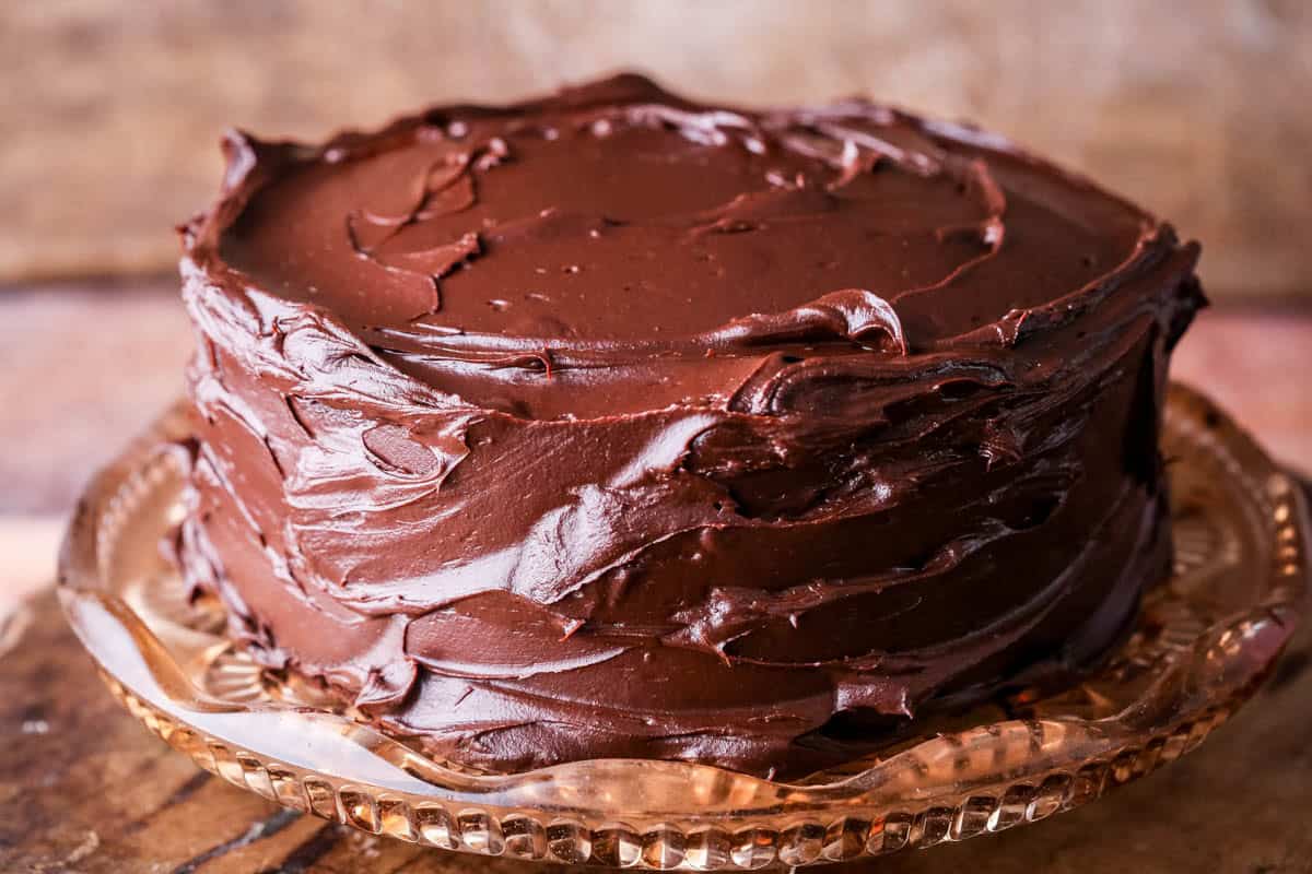 Chocolate Fudge Cake covered in smooth and glossy dark chocolate ganache.