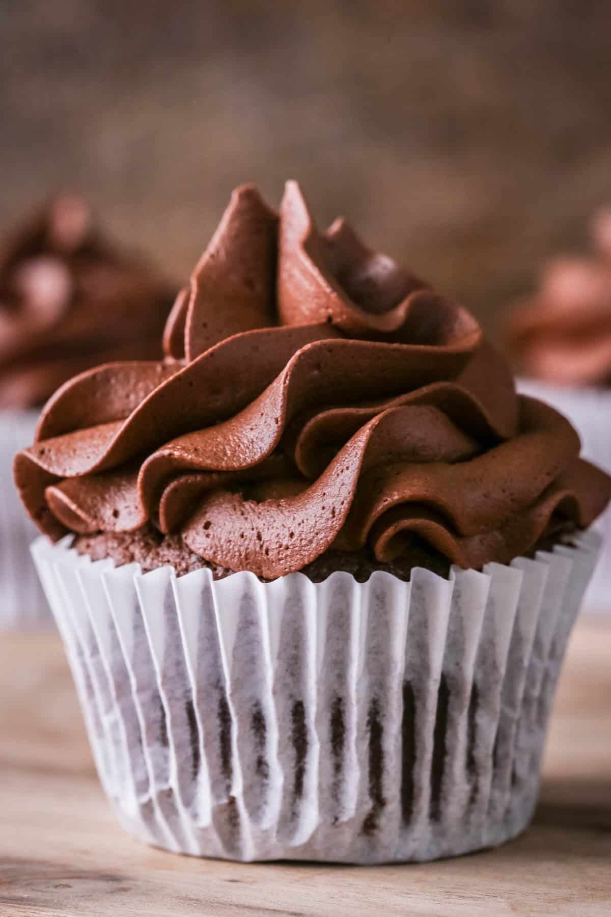 Whipped Chocolate Ganache piped onto a chocolate cupcake.