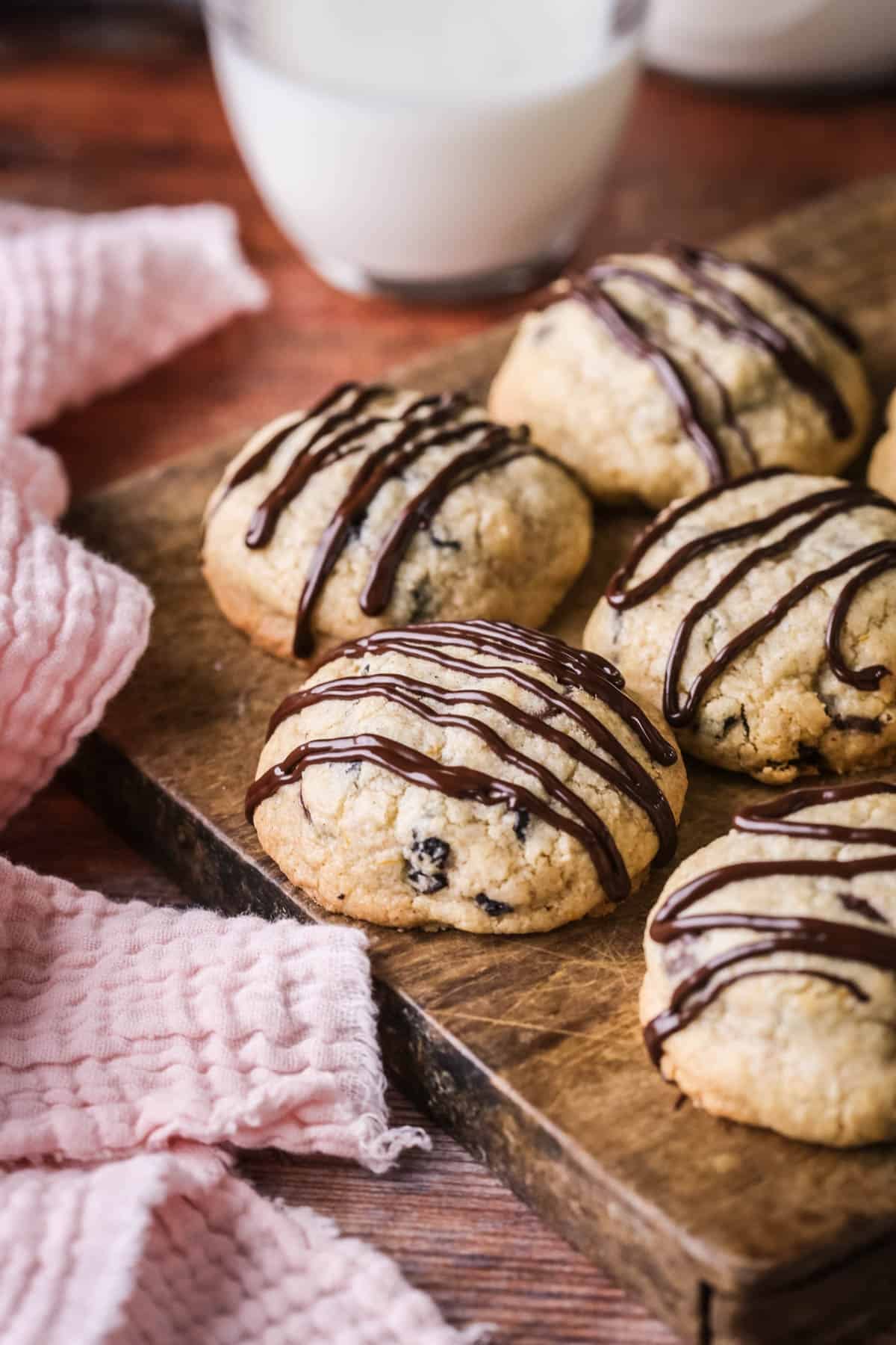 Easter Cookies packed with marzipan, currants, spice and chocolate resting on a wooden board.