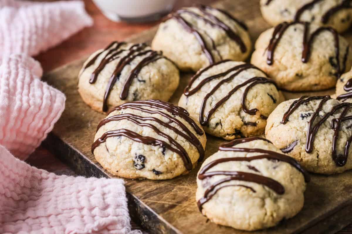 Easter Cookies packed with marzipan, currants, spice and chocolate resting on a wooden board.